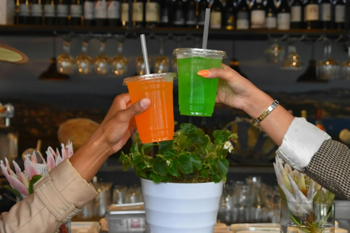 a couple of people that are holding drinks